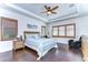 Large main bedroom with hardwood floors, plantation shutters, and ensuite bathroom at 11521 Lake Lucaya Dr, Riverview, FL 33579