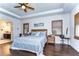 Bright main bedroom with hardwood floors, plantation shutters, and ensuite bath at 11521 Lake Lucaya Dr, Riverview, FL 33579
