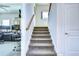 Indoor staircase with carpet runner and wooden handrail at 11521 Lake Lucaya Dr, Riverview, FL 33579