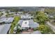 Aerial view of complex with mature trees and landscaping; conveniently located near shopping and business at 1606 Berwick Ct # 10B, Palm Harbor, FL 34684