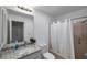 Bright bathroom featuring granite countertops, a sleek vanity, and a shower at 1606 Berwick Ct # 10B, Palm Harbor, FL 34684