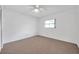 Neutral bedroom featuring a ceiling fan and window at 1606 Berwick Ct # 10B, Palm Harbor, FL 34684