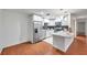 Bright kitchen features stainless steel appliances, stone countertops, and white cabinetry at 1606 Berwick Ct # 10B, Palm Harbor, FL 34684