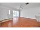 Bright living room with wood-look floors and sliding glass door access to patio at 1606 Berwick Ct # 10B, Palm Harbor, FL 34684