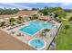 Aerial view of the community pool and spa, surrounded by lush landscaping and comfortable seating at 1606 Berwick Ct # 10B, Palm Harbor, FL 34684