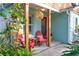 Inviting front porch with red chairs and a wicker pendant light at 119 Irwin, Safety Harbor, FL 34695