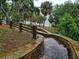 Stone steps leading down to waterfront with wooden fence at 119 Irwin, Safety Harbor, FL 34695