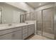 Modern bathroom with double vanity and glass shower at 12355 Hearts Ease St, Venice, FL 34293