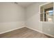 Simple bedroom with wood-look flooring and large window at 12355 Hearts Ease St, Venice, FL 34293