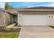 Modern home exterior with two-car garage and landscaped walkway at 12355 Hearts Ease St, Venice, FL 34293