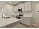 Modern kitchen with stainless steel appliances and white cabinets at 12355 Hearts Ease St, Venice, FL 34293