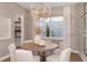 Cozy dining room with a round wooden table and neutral decor at 13813 Sharp Hawk Dr, Riverview, FL 33569