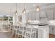 Modern kitchen featuring a large island and white cabinets at 13813 Sharp Hawk Dr, Riverview, FL 33569