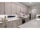 Spacious kitchen with white cabinets, quartz countertops, and stainless steel appliances at 13813 Sharp Hawk Dr, Riverview, FL 33569