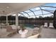 Enclosed pool and spa with patio furniture and screened enclosure at 13813 Sharp Hawk Dr, Riverview, FL 33569