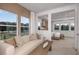 Cozy sitting area with beige sofa and large windows at 13813 Sharp Hawk Dr, Riverview, FL 33569