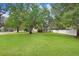 Large backyard with lush grass and mature trees at 2813 Norwood Hills Ln, Valrico, FL 33596