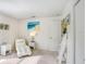 Bright bedroom with chaise lounge and white accents at 2813 Norwood Hills Ln, Valrico, FL 33596