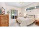 Comfortable bedroom with sliding doors leading to a screened patio and hot tub at 2813 Norwood Hills Ln, Valrico, FL 33596