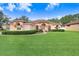 One-story house with a pink facade and a lush green lawn at 2813 Norwood Hills Ln, Valrico, FL 33596