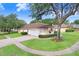 House with a three-car garage and a nicely landscaped yard at 2813 Norwood Hills Ln, Valrico, FL 33596