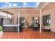 Spacious screened patio featuring a hot tub and fire pit at 2813 Norwood Hills Ln, Valrico, FL 33596