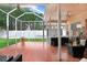 Relaxing screened patio with hot tub, fire pit, and tile flooring at 2813 Norwood Hills Ln, Valrico, FL 33596