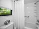 White bathroom with shower/tub combo and window at 413 S Bayshore Blvd # B1, Safety Harbor, FL 34695