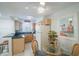 Charming dining area with glass table, wicker chairs, and a view into the kitchen at 600 71St Ave # 17, St Pete Beach, FL 33706