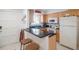 Well-equipped kitchen with a breakfast bar and ample storage at 600 71St Ave # 17, St Pete Beach, FL 33706