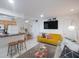 Open living space featuring a mustard sofa and kitchen at 600 71St Ave # 17, St Pete Beach, FL 33706