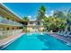 Resort-style pool with adjacent building and lush landscaping at 600 71St Ave # 17, St Pete Beach, FL 33706