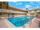 Refreshing community pool with building and lounge chairs at 600 71St Ave # 17, St Pete Beach, FL 33706