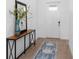 Bright entryway with a console table, mirror, and patterned rug at 10864 Banyan Breeze Blvd, Land O Lakes, FL 34638