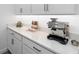 Modern kitchen counter with espresso machine and wine rack at 10864 Banyan Breeze Blvd, Land O Lakes, FL 34638