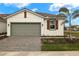 Single-story home with a gray garage door and landscaped yard at 12310 Hearts Ease St, Venice, FL 34293