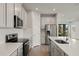 Modern kitchen, stainless steel appliances, and an island with seating at 12310 Hearts Ease St, Venice, FL 34293