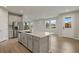 Open kitchen with island, stainless steel appliances, and gray cabinets at 12310 Hearts Ease St, Venice, FL 34293