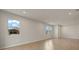 Open living area featuring neutral walls, tile floors, and multiple windows at 12310 Hearts Ease St, Venice, FL 34293