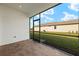 Screened-in porch with paver flooring and backyard view at 12310 Hearts Ease St, Venice, FL 34293