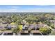 Aerial view of a community with multiple buildings, a pool, and lush landscaping at 1435 Millstream Ln # 202, Dunedin, FL 34698