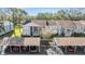 Aerial view of a community with multiple buildings, landscaping, and parking at 1435 Millstream Ln # 202, Dunedin, FL 34698