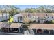 Aerial view of a community with multiple buildings, landscaping, and parking at 1435 Millstream Ln # 202, Dunedin, FL 34698