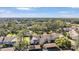 Aerial view of a community with multiple buildings, a pool, and lush landscaping at 1435 Millstream Ln # 202, Dunedin, FL 34698