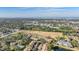 Wide aerial view of community and surrounding area, including water at 1435 Millstream Ln # 202, Dunedin, FL 34698