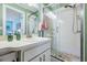 Updated bathroom with a walk-in shower and a modern vanity at 1435 Millstream Ln # 202, Dunedin, FL 34698