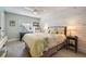 Serene bedroom with wood-paneled wall and light color scheme at 1435 Millstream Ln # 202, Dunedin, FL 34698