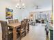 Dining area with a wooden table and chairs, adjacent to the living room at 1435 Millstream Ln # 202, Dunedin, FL 34698