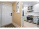 Kitchen and entryway with modern appliances and light paint at 1435 Millstream Ln # 202, Dunedin, FL 34698