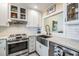 Modern kitchen with stainless steel appliances and white cabinets at 1435 Millstream Ln # 202, Dunedin, FL 34698
